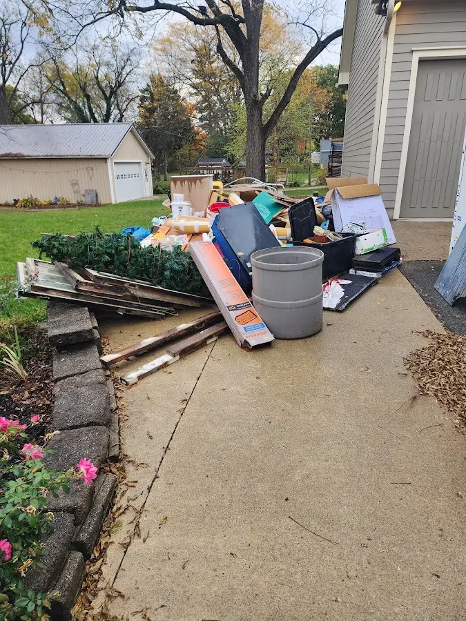 Dumpster being loaded with debris for Estate Cleanout Dumpster Rental in Highlands